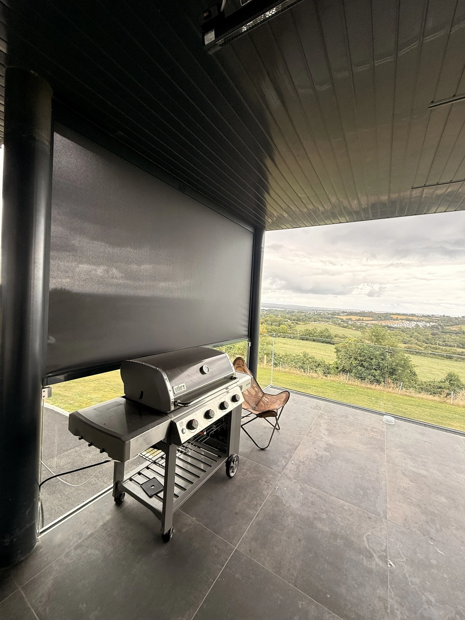 Motorised ZIP screen providing privacy and shelter on an elevated terrace in Ireland